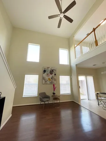 a room with wooden floor and window