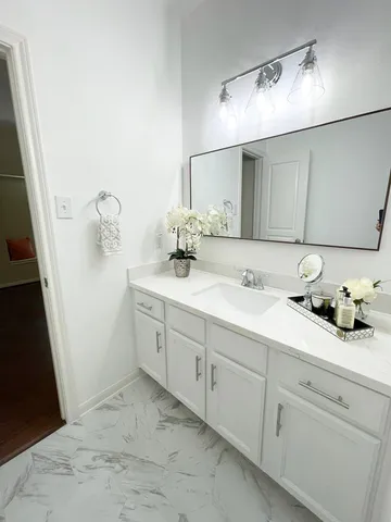 a spacious bathroom with double sink and a mirror