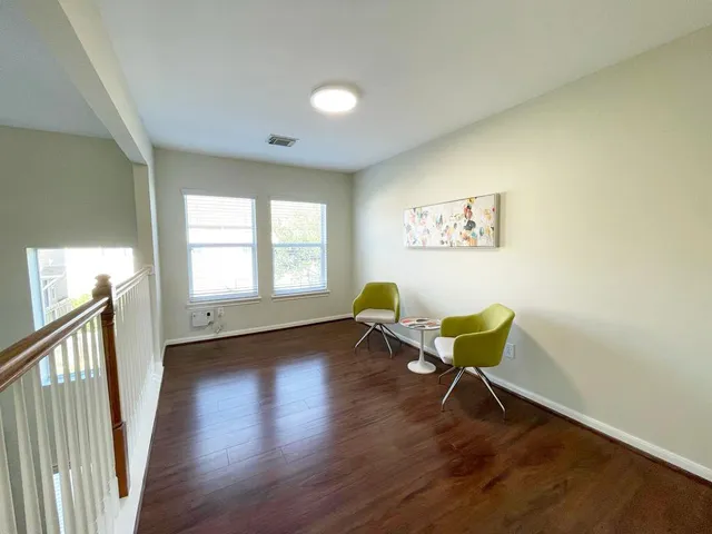 a view of a room with wooden floor and a window
