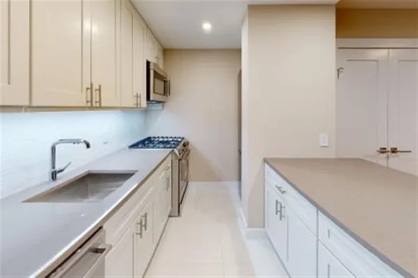a kitchen with a sink and cabinets