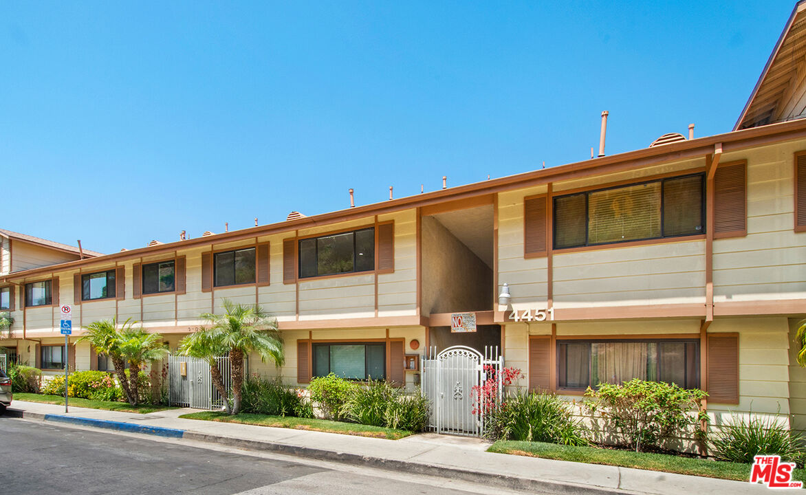 4451 Don Ricardo Drive, Unit 9 Los Angeles, CA 90008 - Photo 1 of 23 a front view of a house with a yard