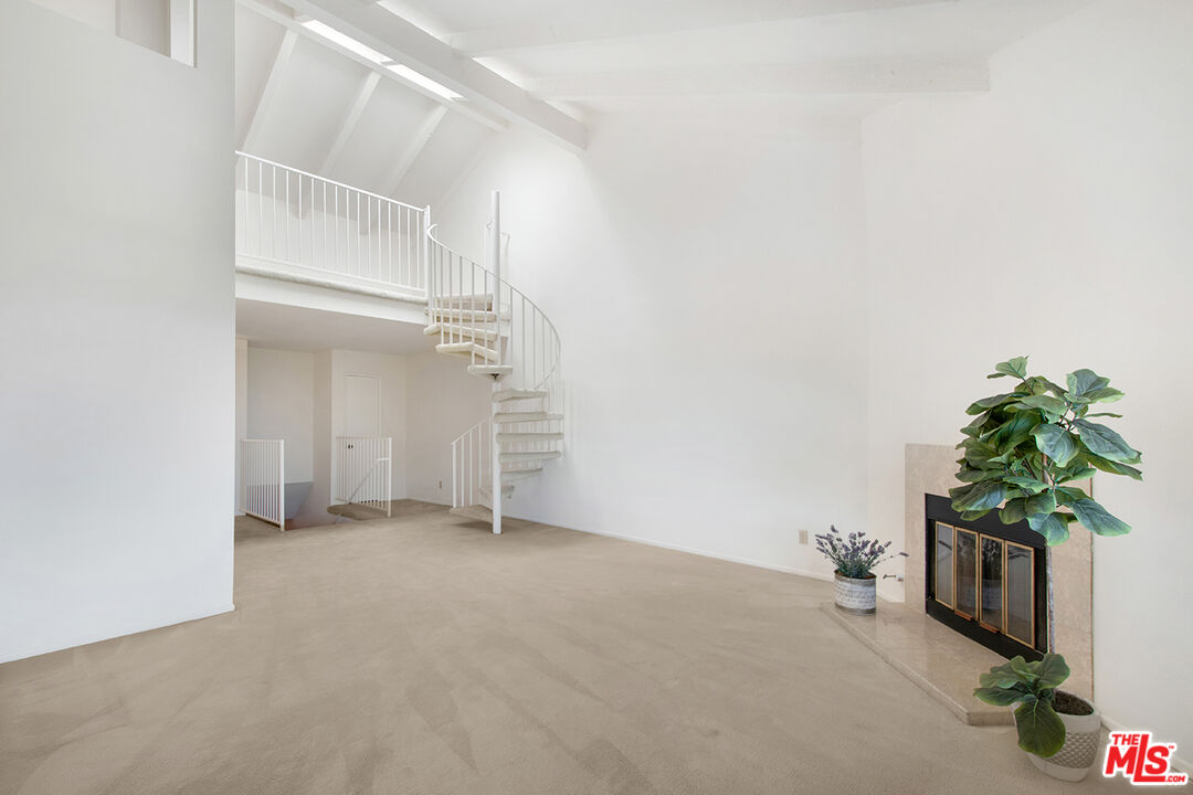 4451 Don Ricardo Drive, Unit 9 Los Angeles, CA 90008 - Photo 16 of 23 an empty room with windows and flower pot