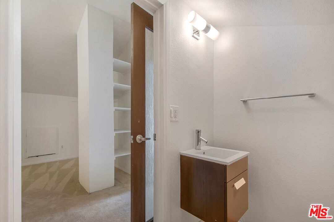 4451 Don Ricardo Drive, Unit 9 Los Angeles, CA 90008 - Photo 18 of 23 a bathroom with a sink and a mirror