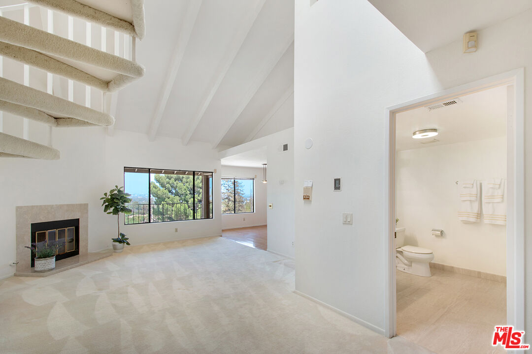 4451 Don Ricardo Drive, Unit 9 Los Angeles, CA 90008 - Photo 2 of 23 a view of a livingroom with a fireplace and window