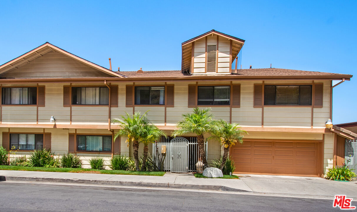 4451 Don Ricardo Drive, Unit 9 Los Angeles, CA 90008 - Photo 22 of 23 a front view of a house with a yard