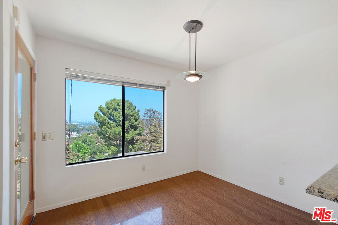 4451 Don Ricardo Drive, Unit 9 Los Angeles, CA 90008 - Photo 4 of 23 a view of empty room with window and wooden floor