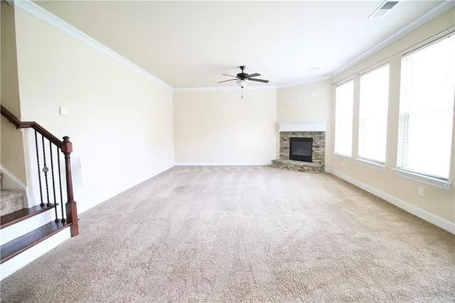 a view of empty room with a fireplace