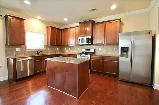 a kitchen with a sink stove and refrigerator
