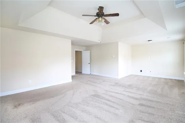 a view of a livingroom with a ceiling fan and window