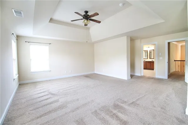 a view of a livingroom with a ceiling fan and window