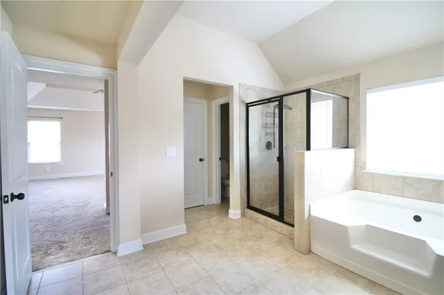 a bathroom with a tub shower and sink