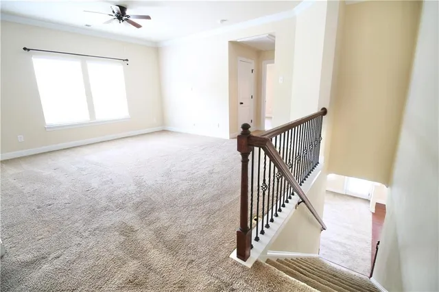 an entryway in a hall with wooden floor and a window