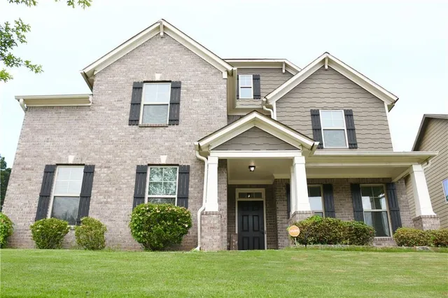 a front view of a house with a yard