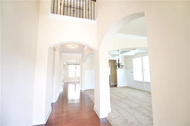 a view of a hallway with wooden floor