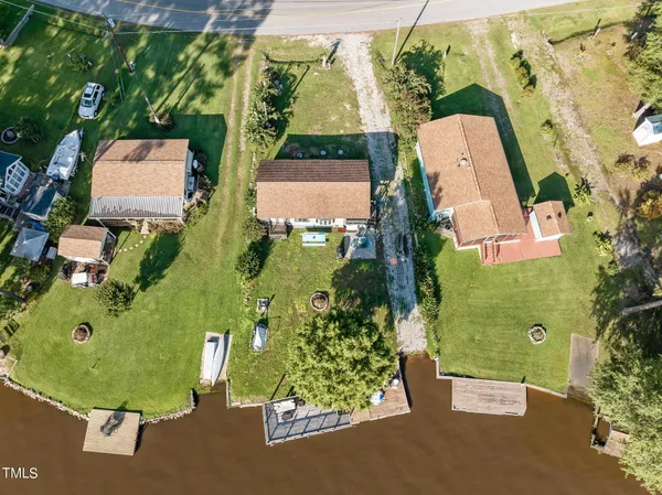 an aerial view of a house with garden space and street view