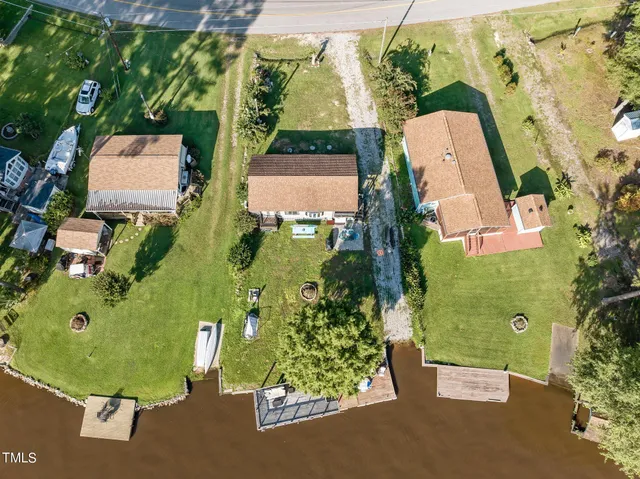 an aerial view of a house with garden space and street view