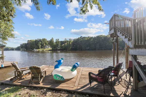 a view of a lake with table and chairs