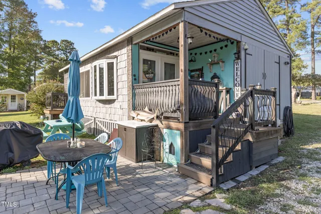 a front view of a house with a yard table and chairs