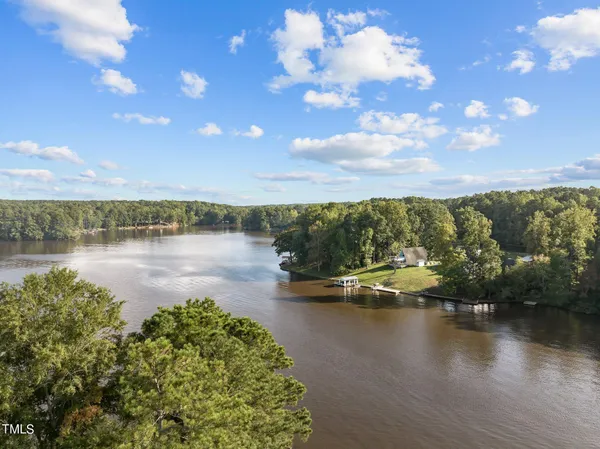 a view of a lake with houses in the back