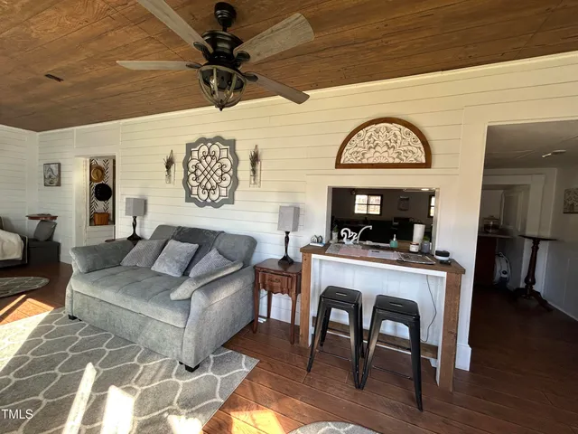 a living room with furniture a rug and a window