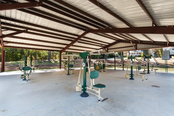 a view of a swimming pool with sitting area and furniture