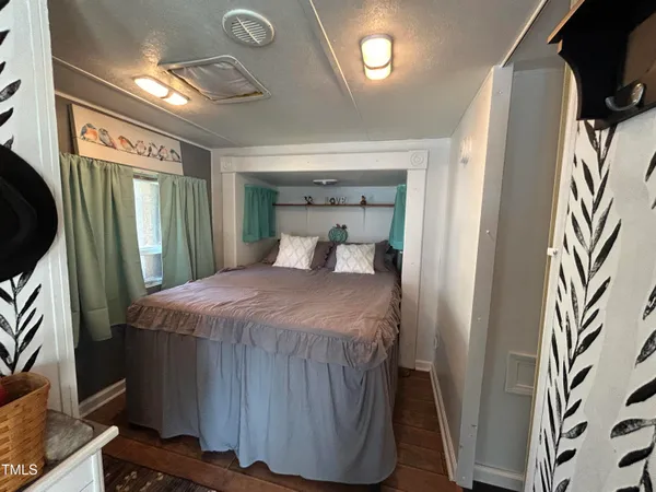 a bedroom with a bed and a mirror