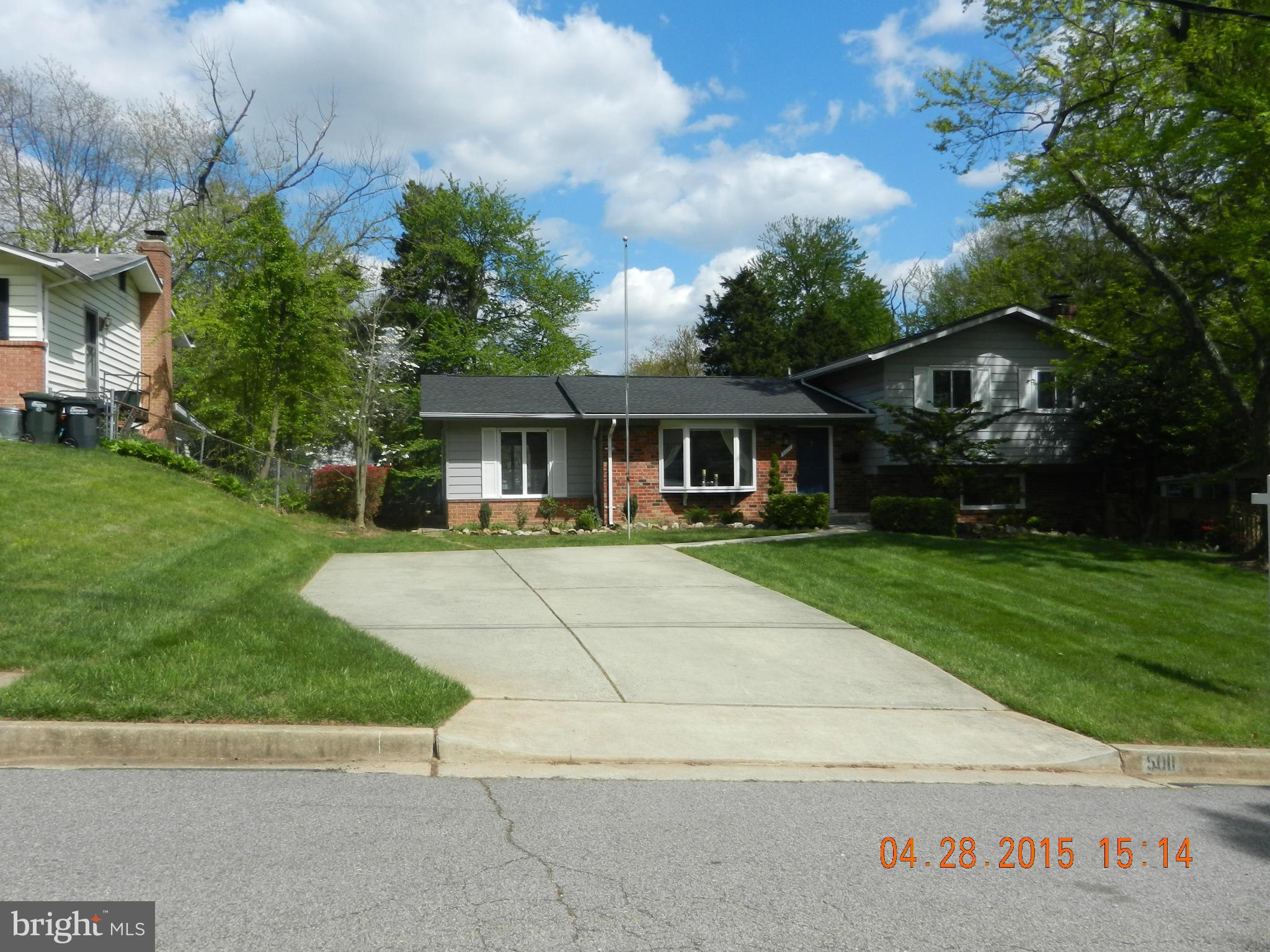 5011 Roslyn Road Annandale, VA 22003 - Photo 2 of 28 a front view of a house with a yard and potted plants