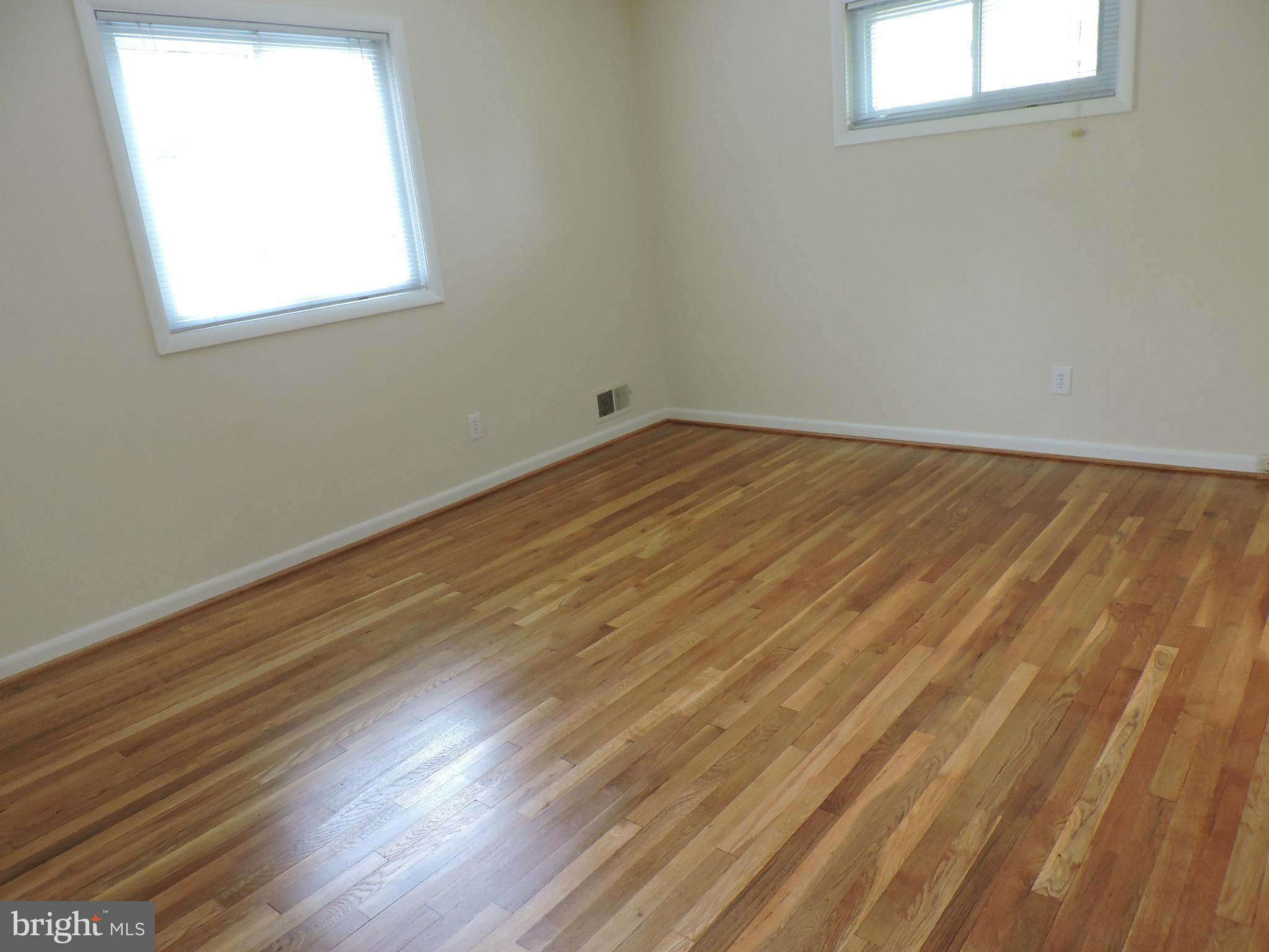 5011 Roslyn Road Annandale, VA 22003 - Photo 21 of 28 an empty room with wooden floor and windows