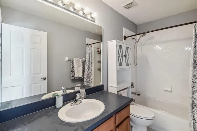 an aerial view of residential houses with outdoor space and swimming pool