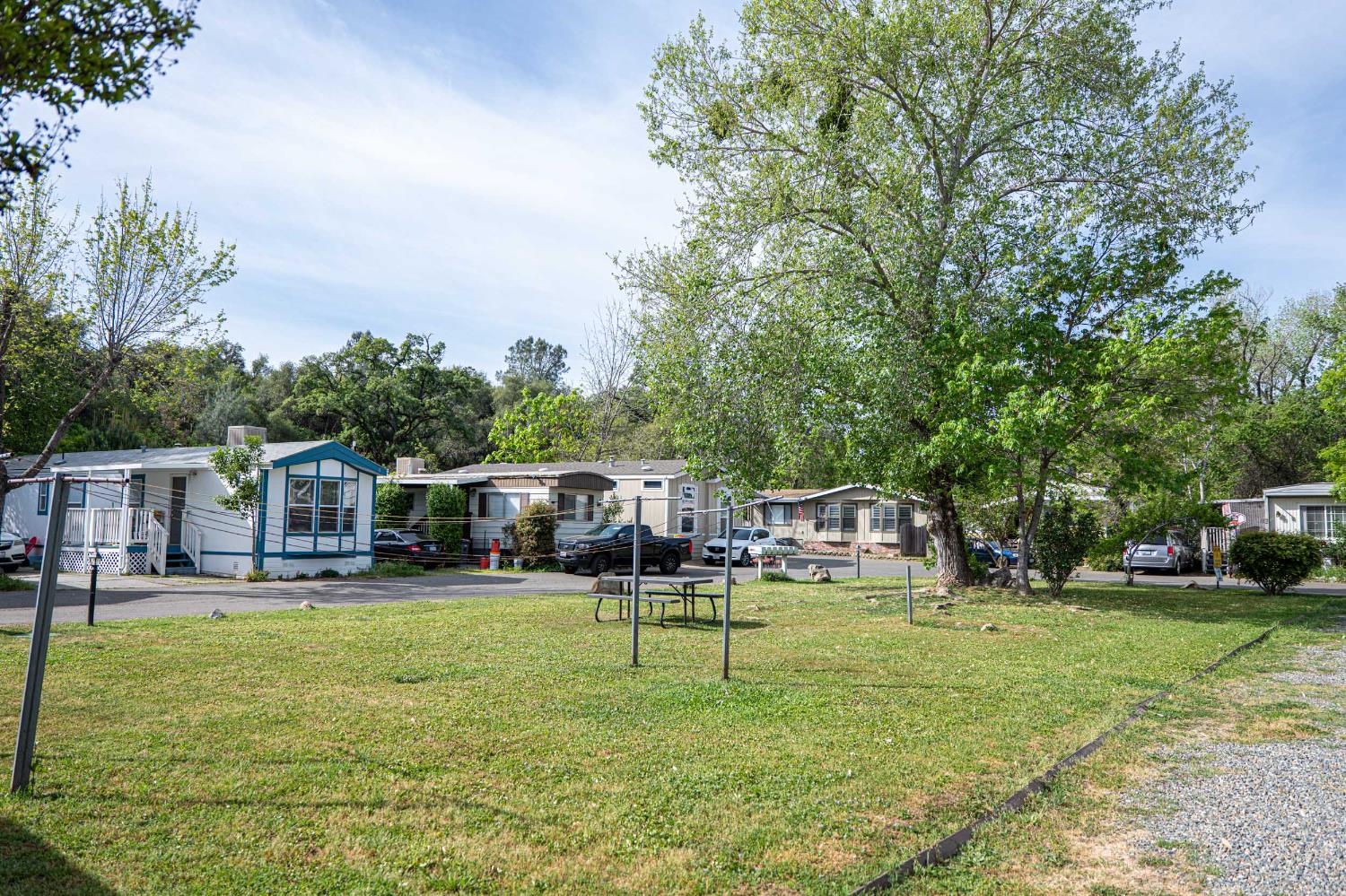 6540 Virginiatown Road, Unit 30 Newcastle, CA 95658 - Photo 17 of 24 a house view with swimming pool and trees in the background