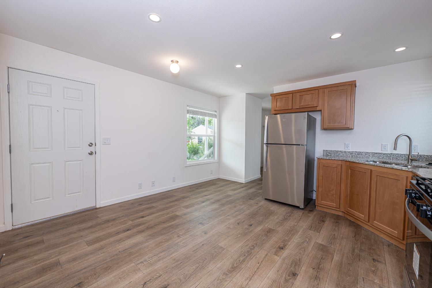 6540 Virginiatown Road, Unit 30 Newcastle, CA 95658 - Photo 7 of 24 a view of a kitchen with a sink and a refrigerator