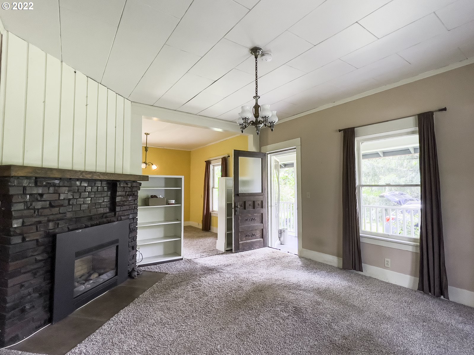 54647 Southwest Patton Valley Road Gaston, OR 97119 - Photo 11 of 29 a view of an empty room with a fireplace and a window