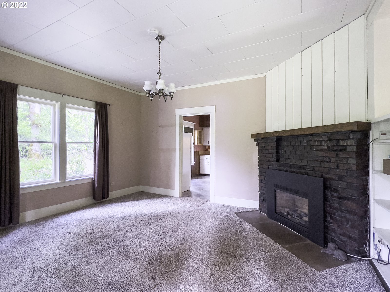 54647 Southwest Patton Valley Road Gaston, OR 97119 - Photo 12 of 29 a view of an empty room with a fireplace and a window