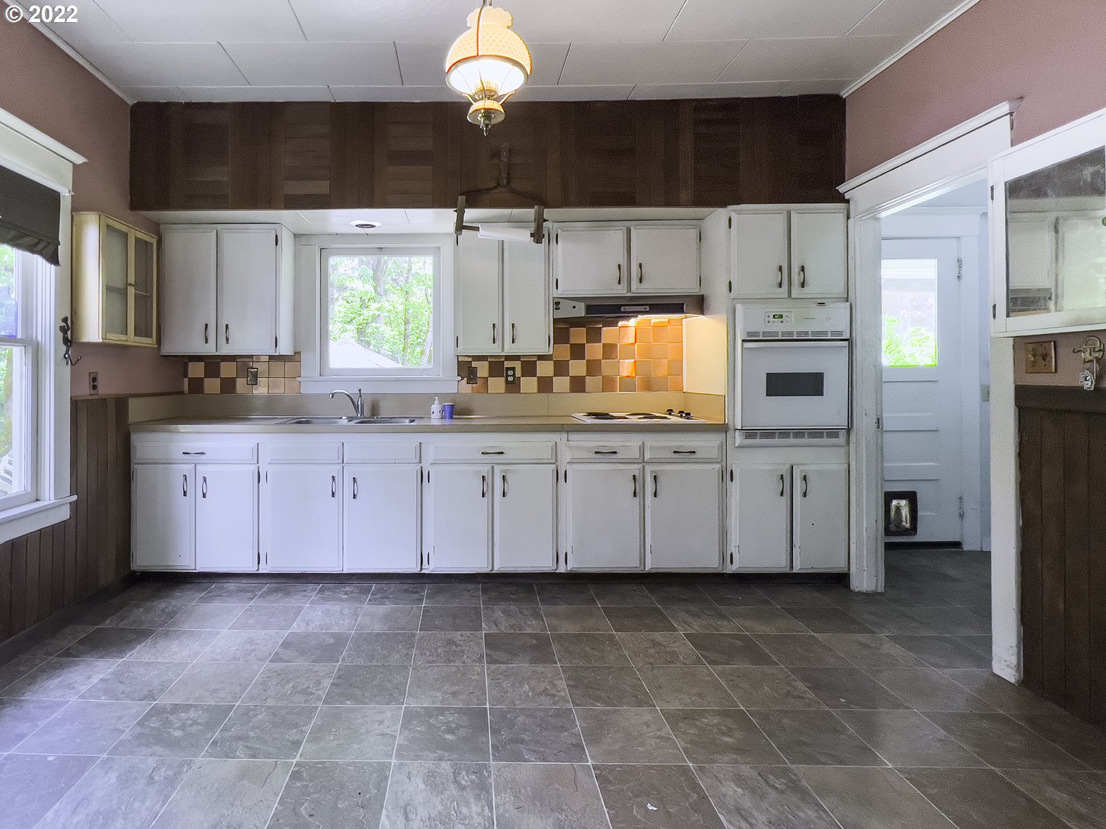 54647 Southwest Patton Valley Road Gaston, OR 97119 - Photo 8 of 29 a kitchen with stainless steel appliances a sink a stove a refrigerator cabinets and a window