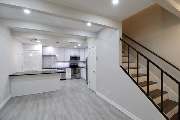 a view of kitchen with wooden floor and electronic appliances