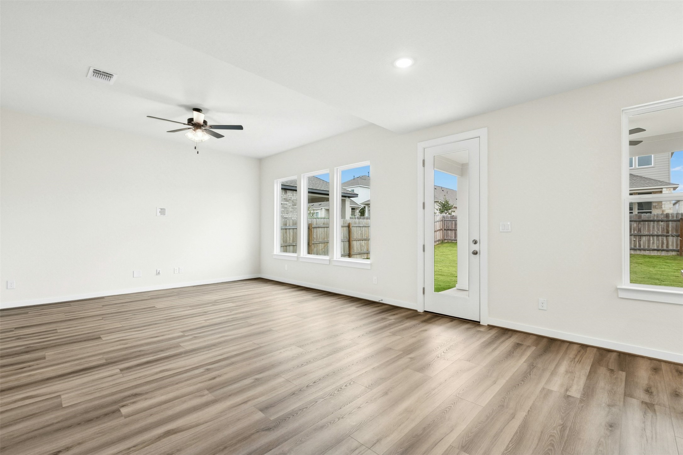 4313 Contrail Lane Round Rock, TX 78665 - Photo 4 of 32 a view of an empty room with a window and wooden floor