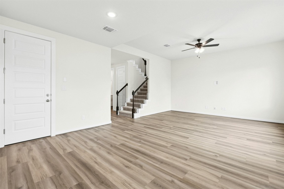 4313 Contrail Lane Round Rock, TX 78665 - Photo 5 of 32 a view of empty room with wooden floor and fan