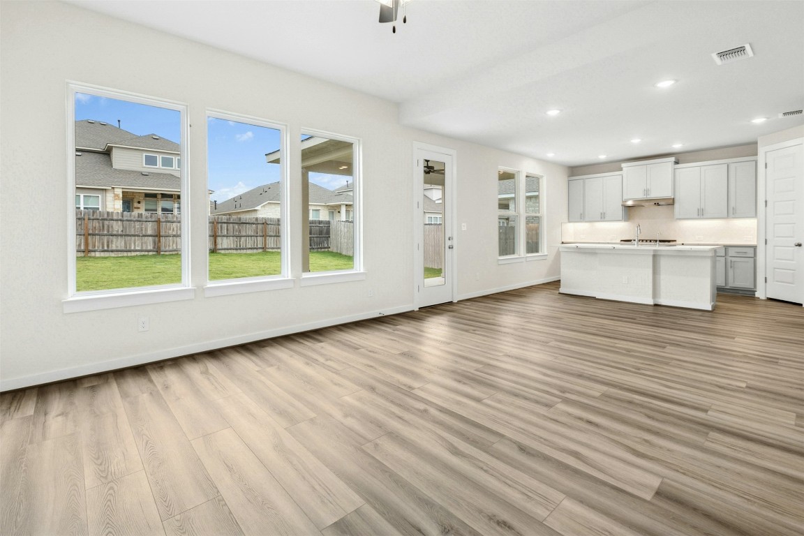 4313 Contrail Lane Round Rock, TX 78665 - Photo 6 of 32 a view of an empty room with wooden floor and a window