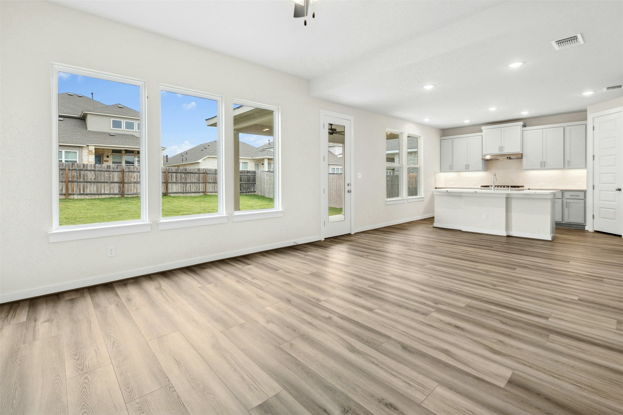 4313 Contrail Lane Round Rock, TX 78665 - Photo 6 of 32 a view of an empty room with wooden floor and a window
