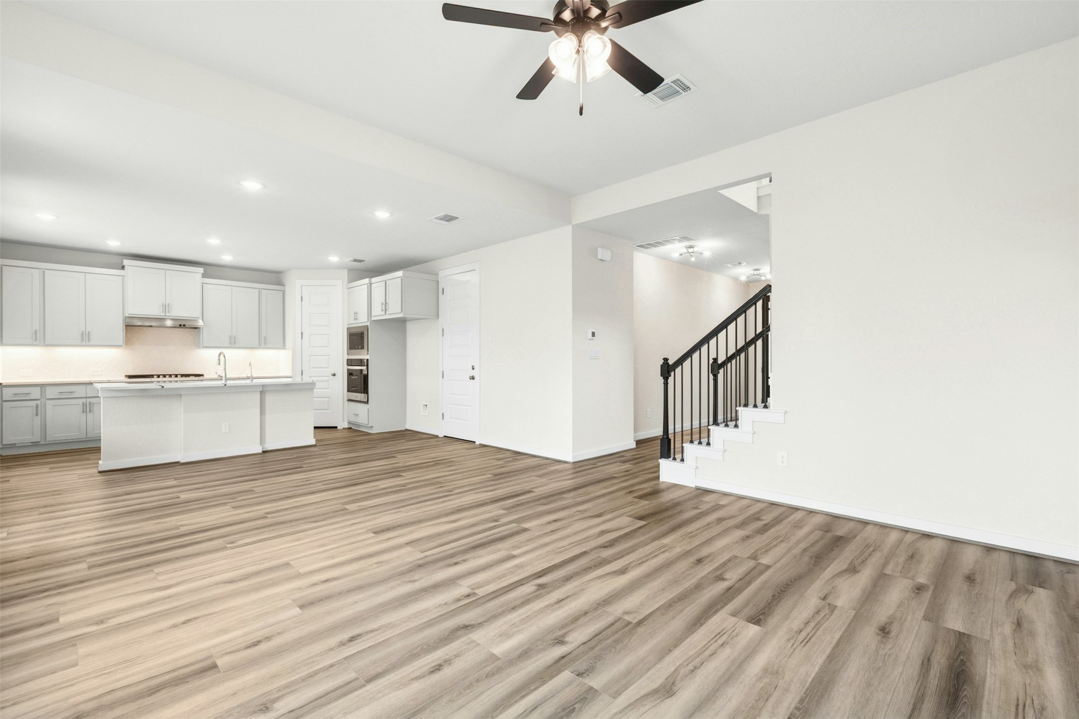 4313 Contrail Lane Round Rock, TX 78665 - Photo 7 of 32 a view of a kitchen with a sink and a refrigerator