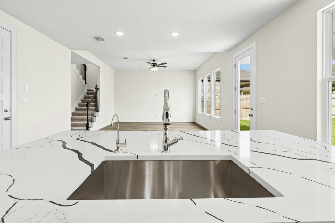 4313 Contrail Lane Round Rock, TX 78665 - Photo 10 of 32 a kitchen with a sink and a refrigerator