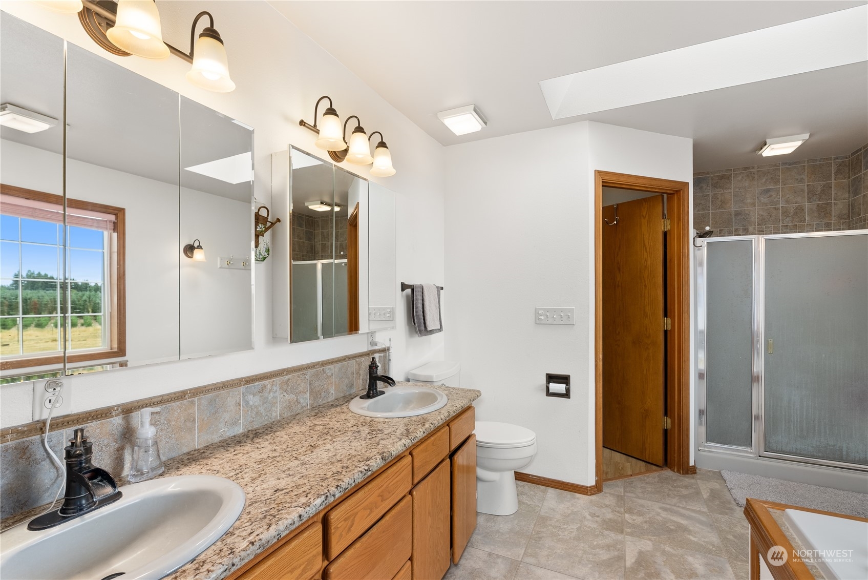 169 Conradi Road Winlock, WA 98596 - Photo 16 of 38 a bathroom with a granite countertop sink and a mirror