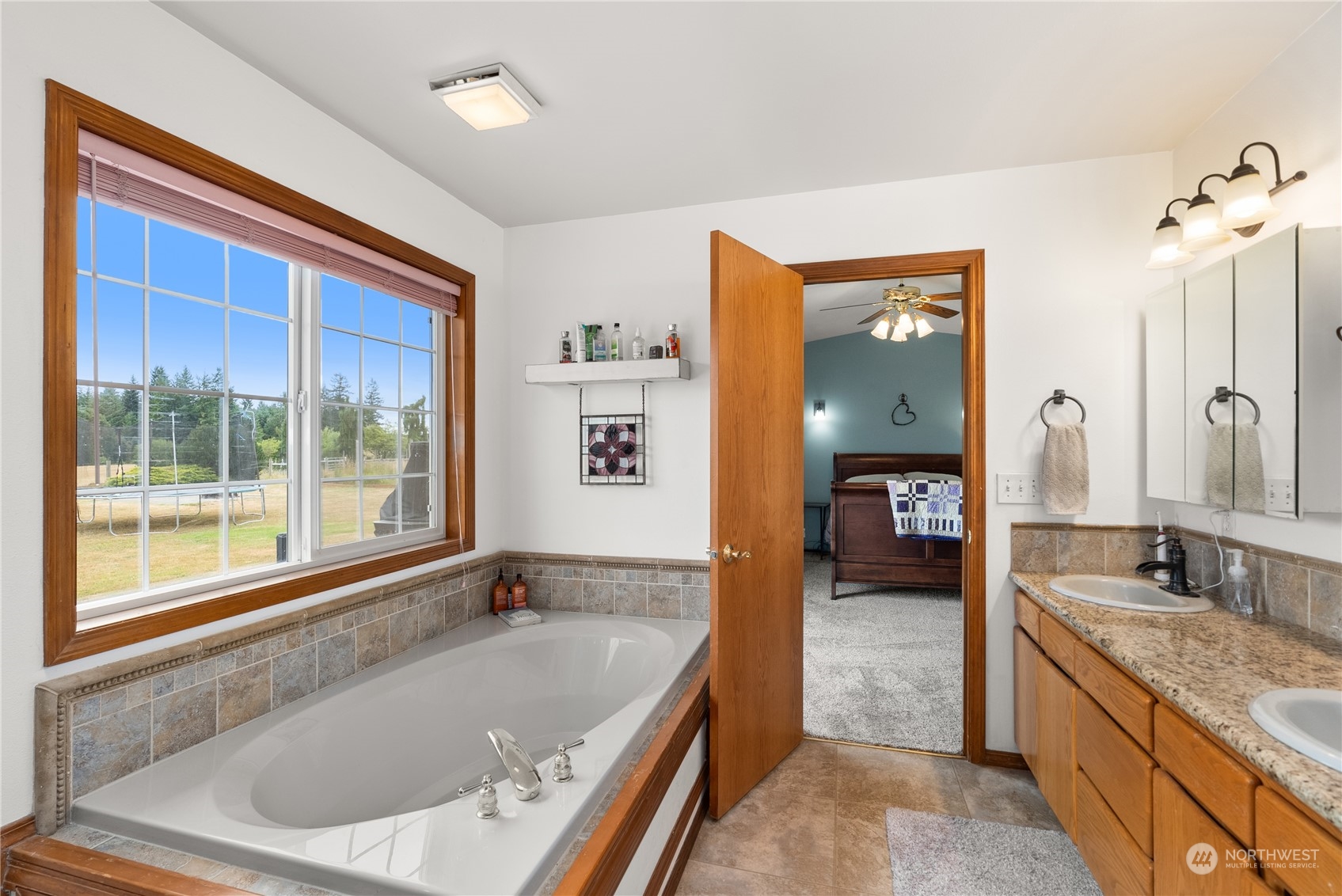 169 Conradi Road Winlock, WA 98596 - Photo 17 of 38 a bathroom with a granite countertop tub sink and mirror