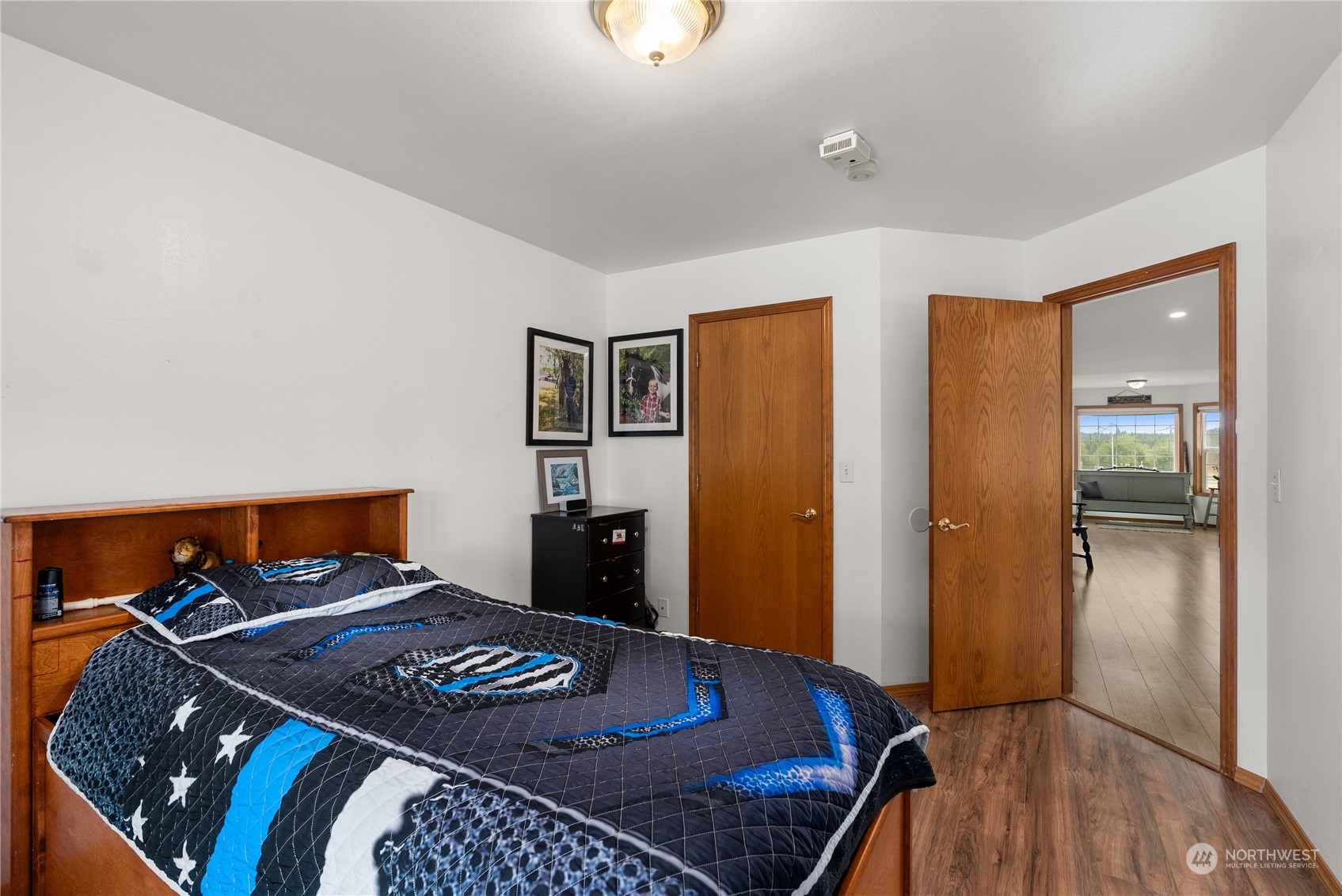169 Conradi Road Winlock, WA 98596 - Photo 19 of 38 a bedroom with a bed and wooden floor