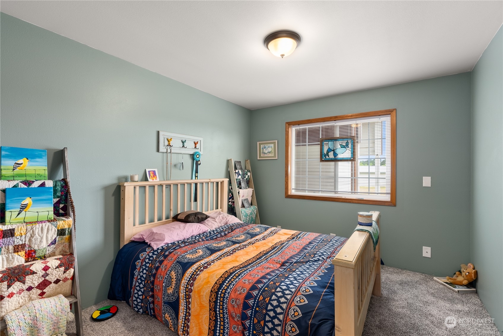 169 Conradi Road Winlock, WA 98596 - Photo 21 of 38 a bed sitting in a bedroom next to a window