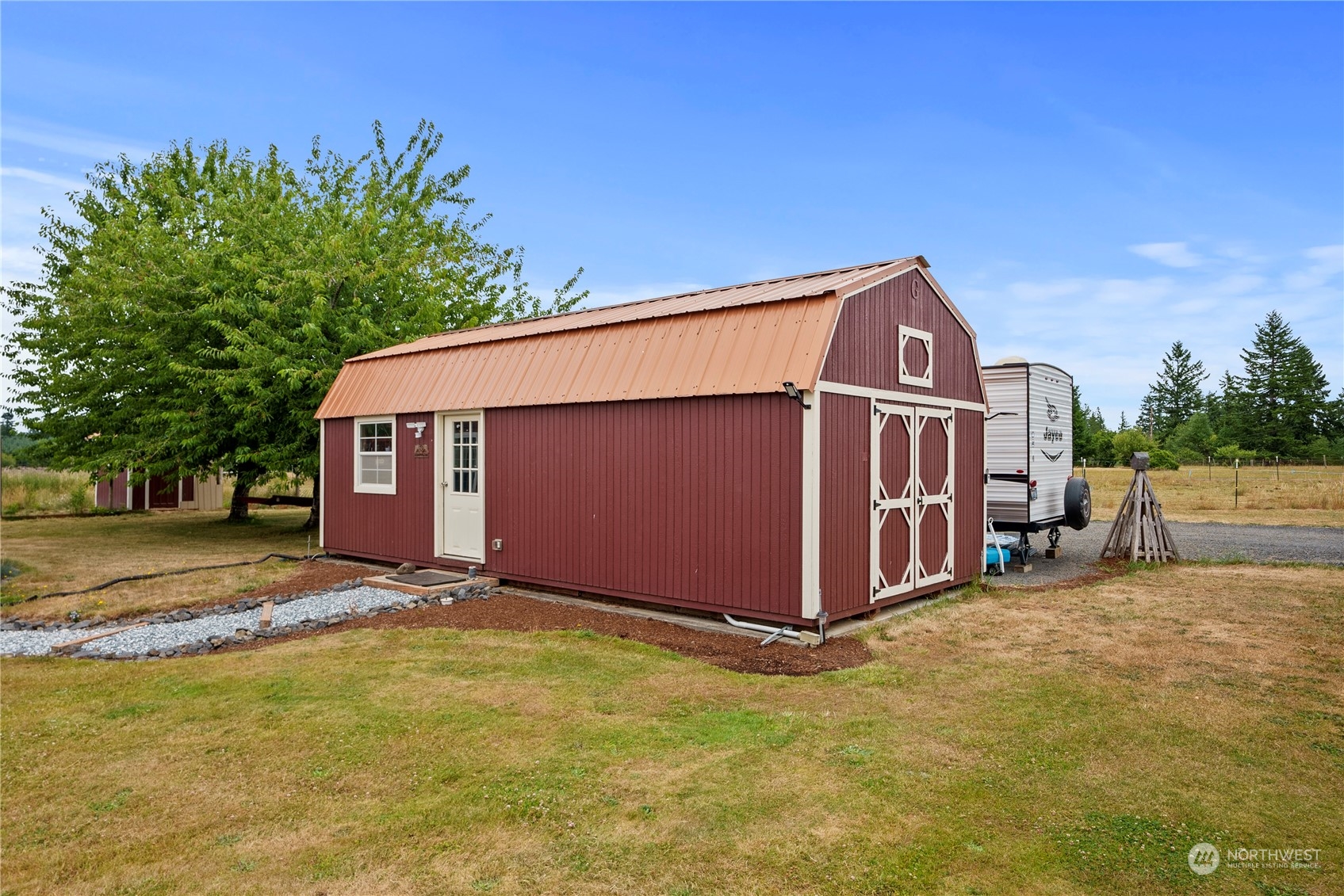 169 Conradi Road Winlock, WA 98596 - Photo 24 of 38 a view of a blue house with a big yard and large trees