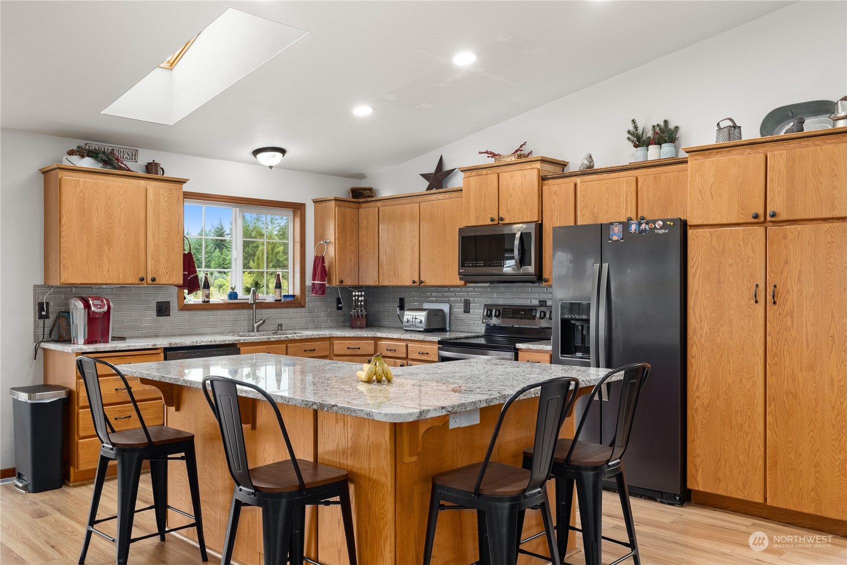 169 Conradi Road Winlock, WA 98596 - Photo 10 of 38 a kitchen with stainless steel appliances granite countertop a dining table and chairs