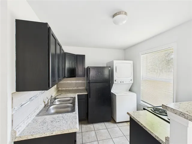 a kitchen with a refrigerator and a stove