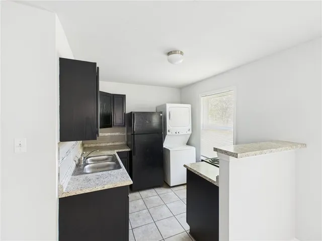 a kitchen with a refrigerator and a stove