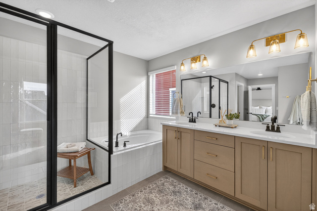 2841 West 2705 North, Unit 69 Ogden, UT 84404 - Photo 15 of 31 Contemporary bathroom featuring a spacious walk-in shower with black-framed glass, a built-in soaking tub, and a dual vanity with light-colored cabinetry